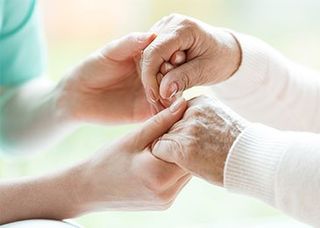 Medicaid Expert Holding Elderly's Hands — Bluffton, IN — Jerry Flack & Associates