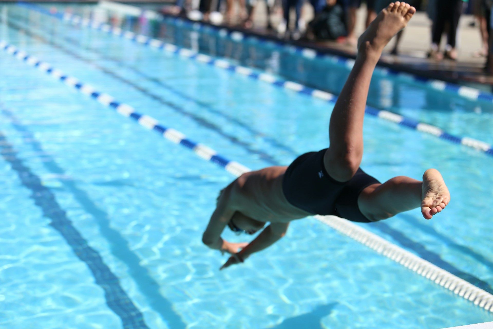 kid diving into the pool