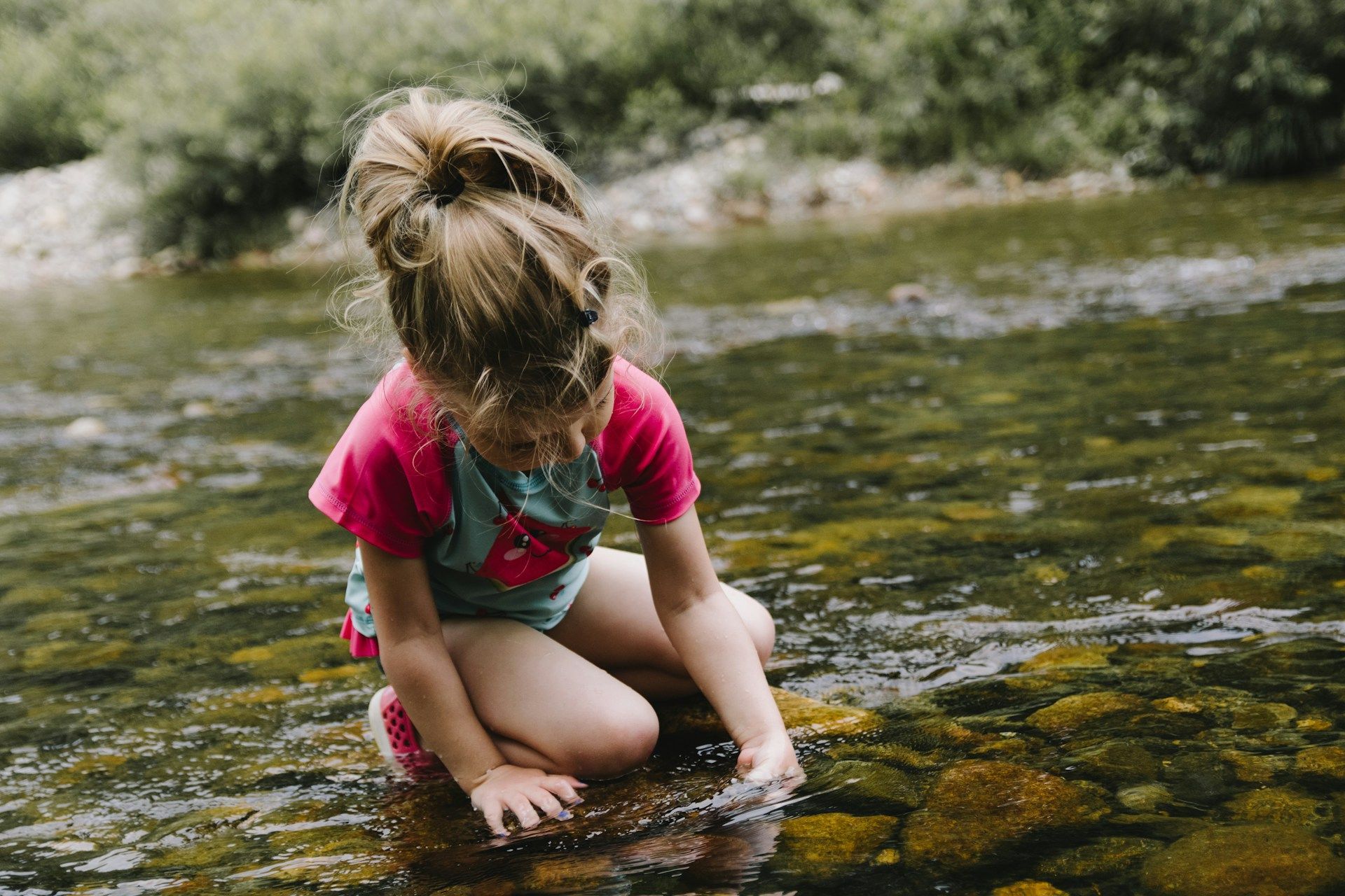 girl playing in the river