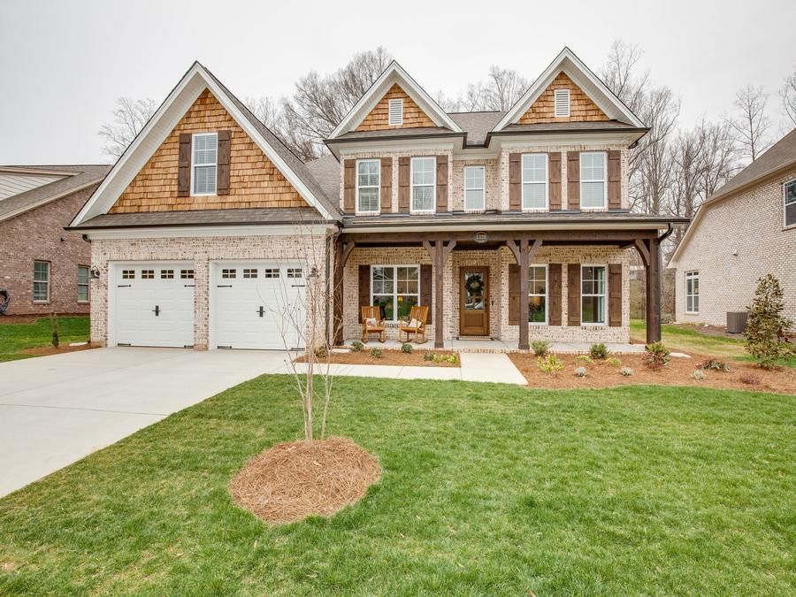A large house with a large lawn in front of it.