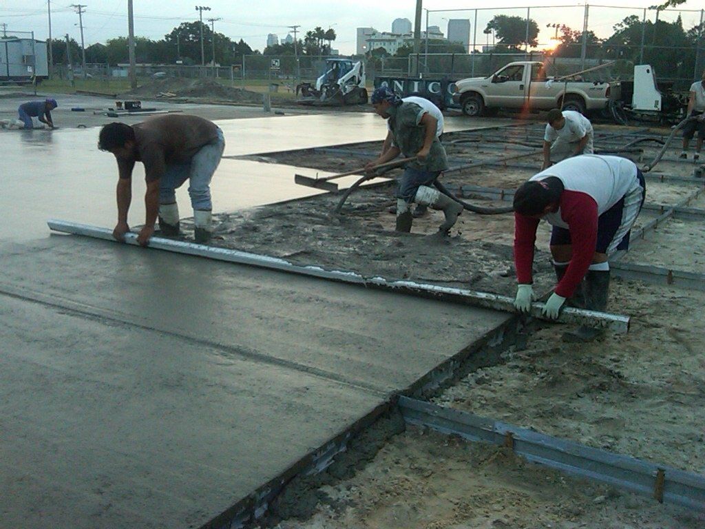 Workers Cementing a Ground for Basketball Court — Tampa, FL — George Gsolar & Co.