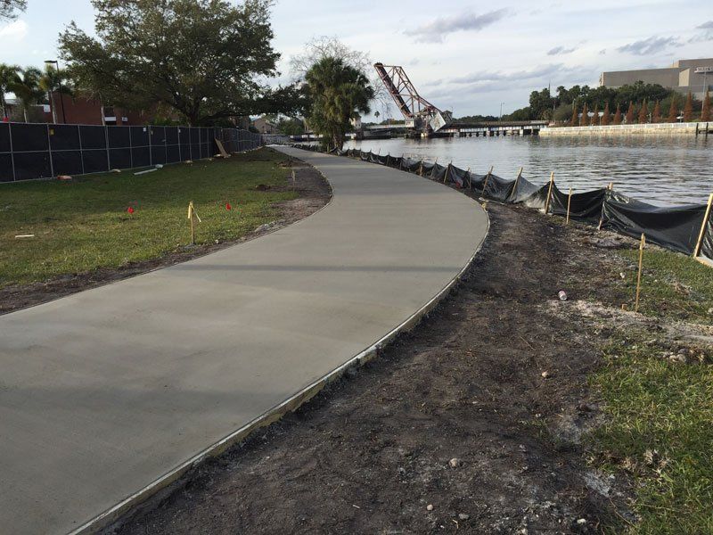 Sidewalk Beside River — Tampa, FL — George Gsolar & Co.