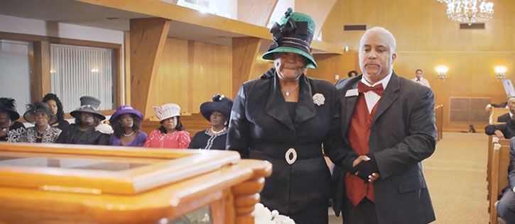 African American woman and man at a funeral in a church