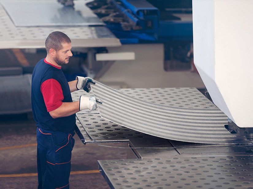 Metal Press Machine Holding a Piece of Steel —  Metal Fabrication & Welding in Garbutt, QLD