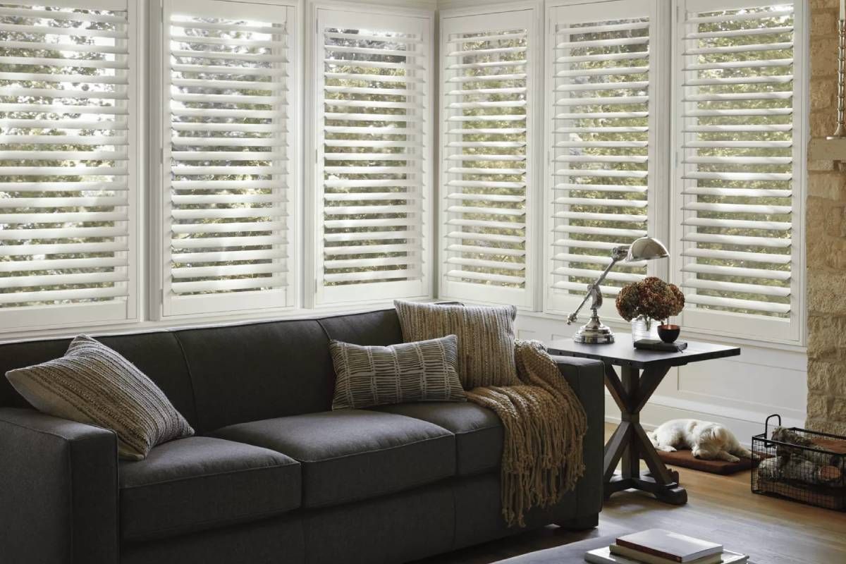 Hunter Douglas NewStyle® Composite Shutters Tilted Open in a Living Room