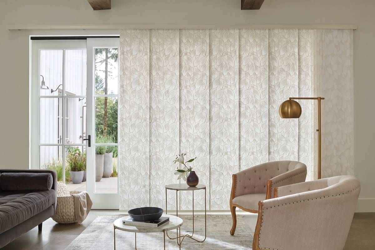 Hunter Douglas Skyline® Panel-Track Blinds with a botanical-like pattern on a sliding glass door at Maple Drapery & Carpet