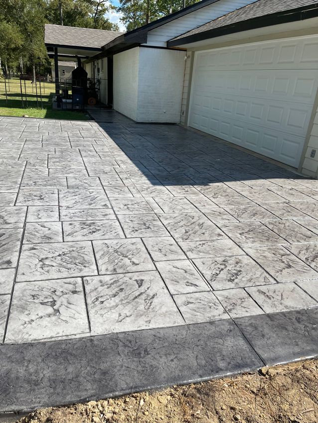A large house with a concrete driveway in front of it