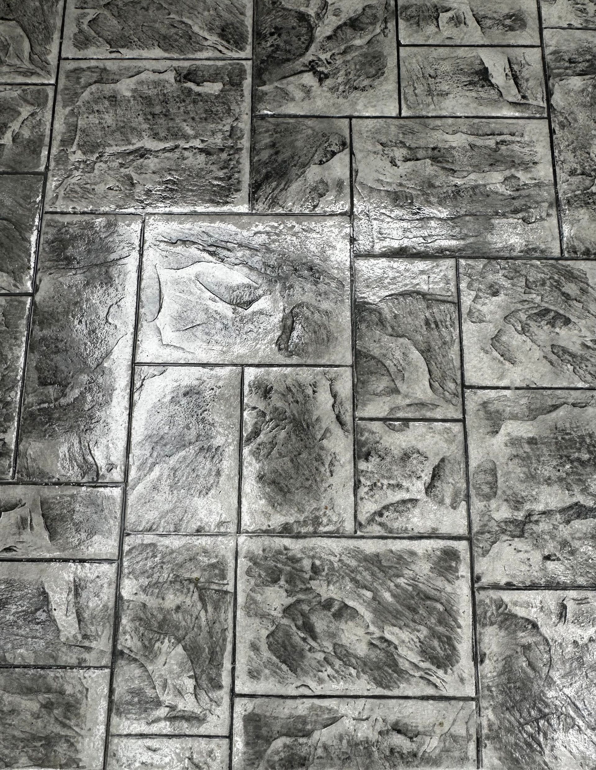 A black and white photo of a brick floor.