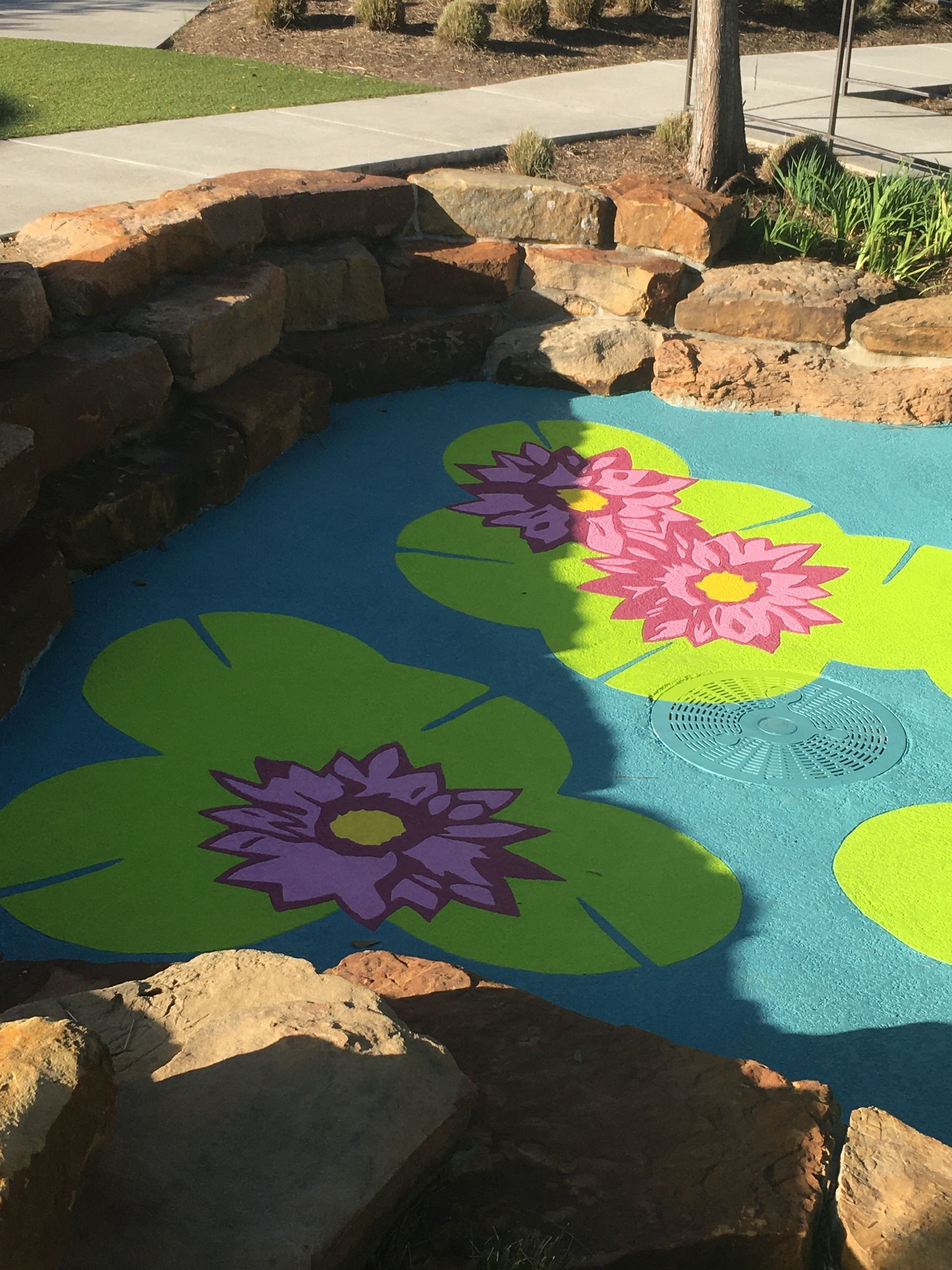 A painting of flowers on the ground in a park