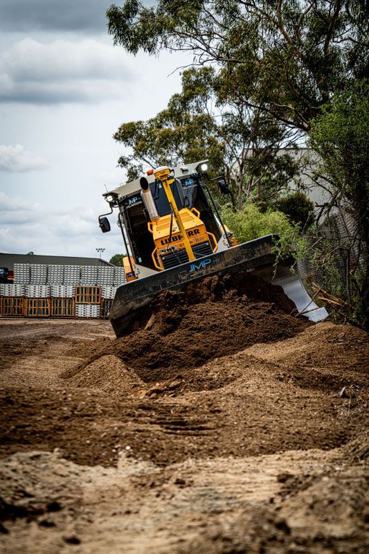 A bulldozer is moving dirt on a construction site.