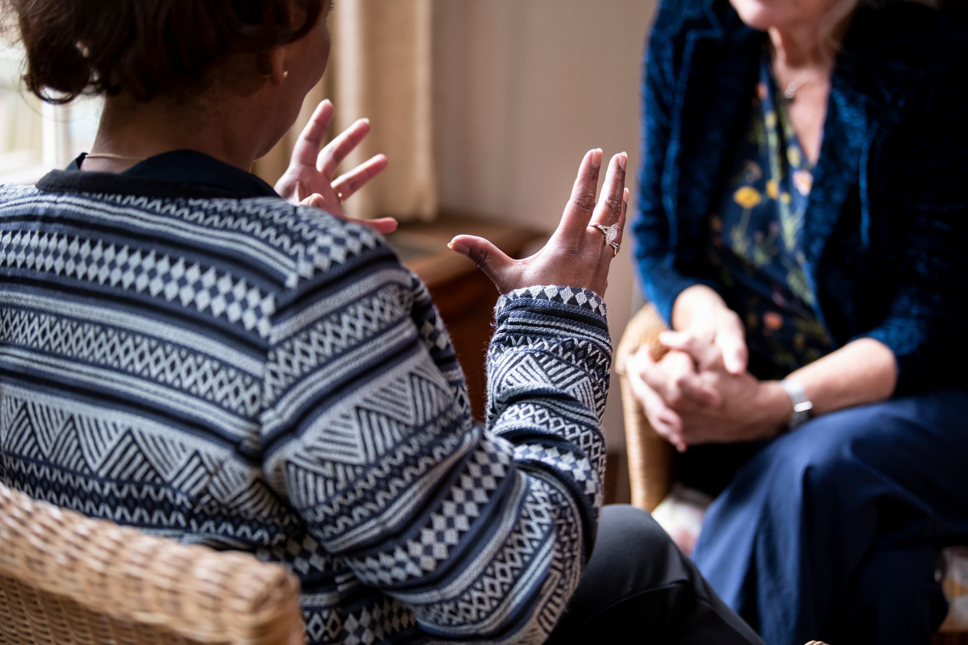 A man and a woman are sitting on a couch, talking. A man and a woman are sitting on a couch, talking.
