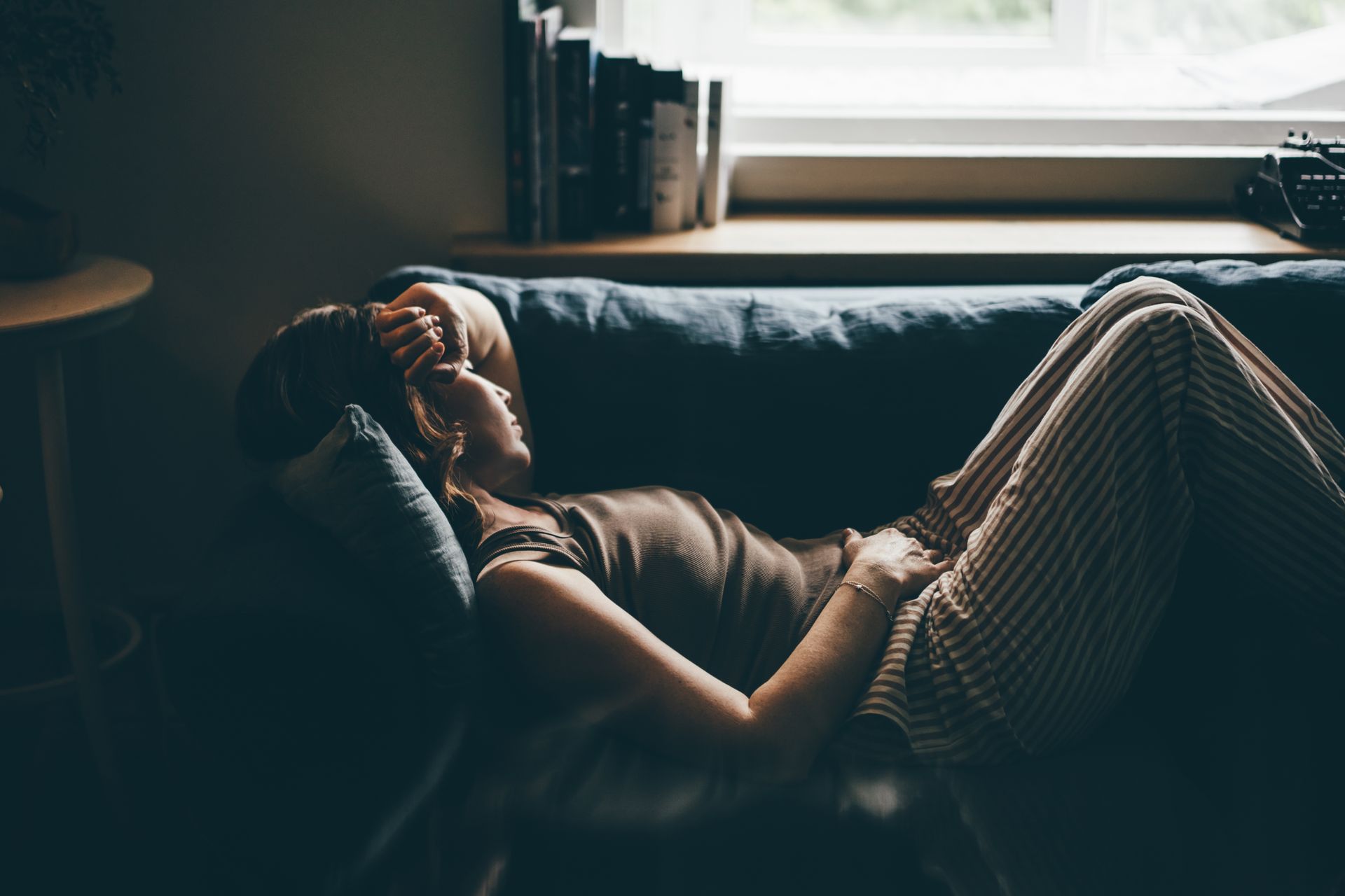 A nurse is kneeling down to talk to a woman who is sitting in a chair. A nurse is kneeling down to talk to a woman who is sitting in a chair.