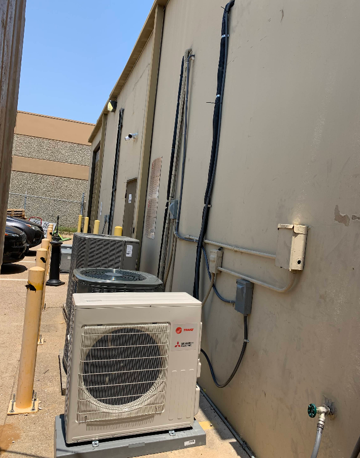 An lg air conditioner is sitting outside of a building