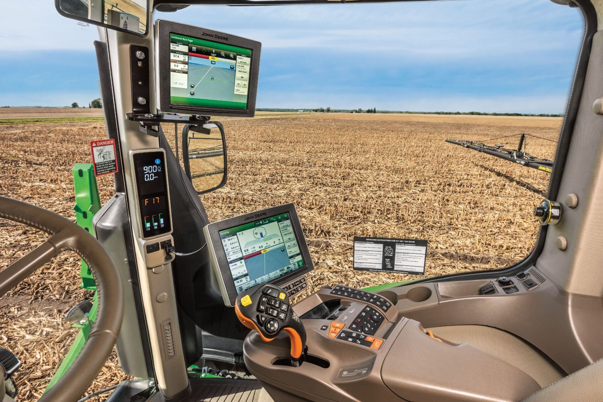 View of control screens in John Deere Combine cab