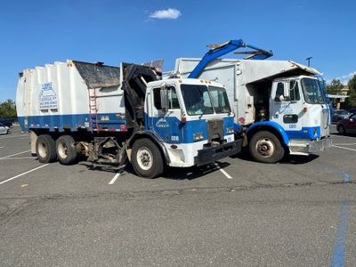Garbage Truck Picking Up the Trash — Dumont, CO — Doyle Disposal