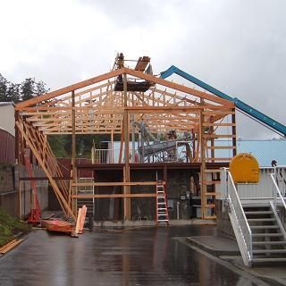 A large wooden structure is being built on top of a building.