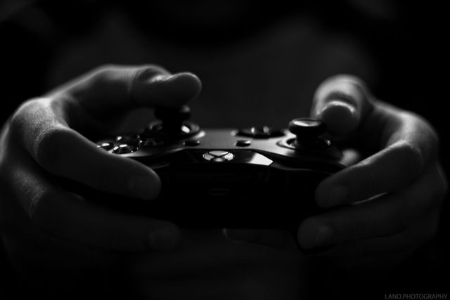 A person is holding a video game controller in their hands.