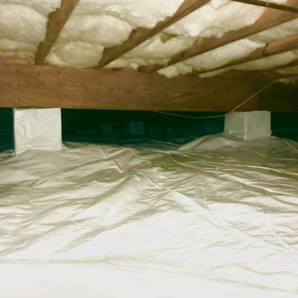 a basement with a lot of insulation and plastic on the floor .