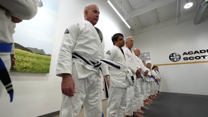 Adults practicing Jiu-Jitsu positional control at Academy of Jiu-Jitsu Scottsdale in Scottsdale, AZ.