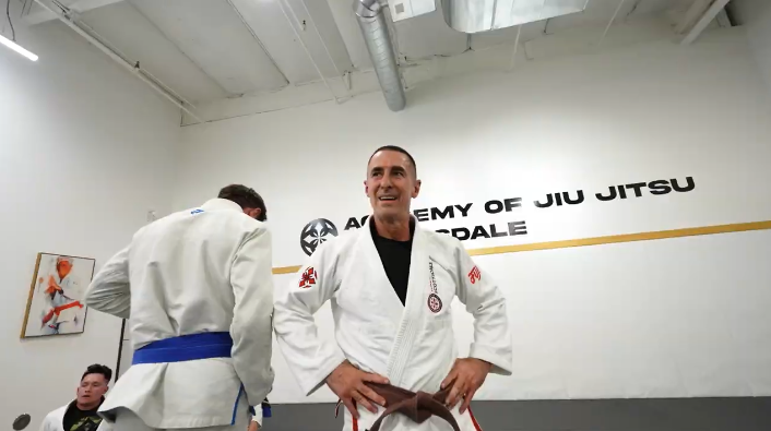 Adults drilling jiu-jitsu technique at Academy of Jiu-Jitsu Scottsdale in Scottsdale, AZ for confide