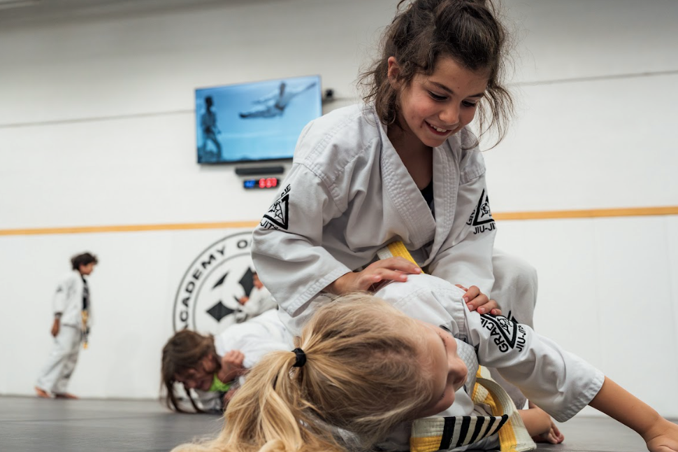 Kids practicing karate drills at Academy of Jiu-Jitsu Scottsdale in Scottsdale, AZ to build focus.