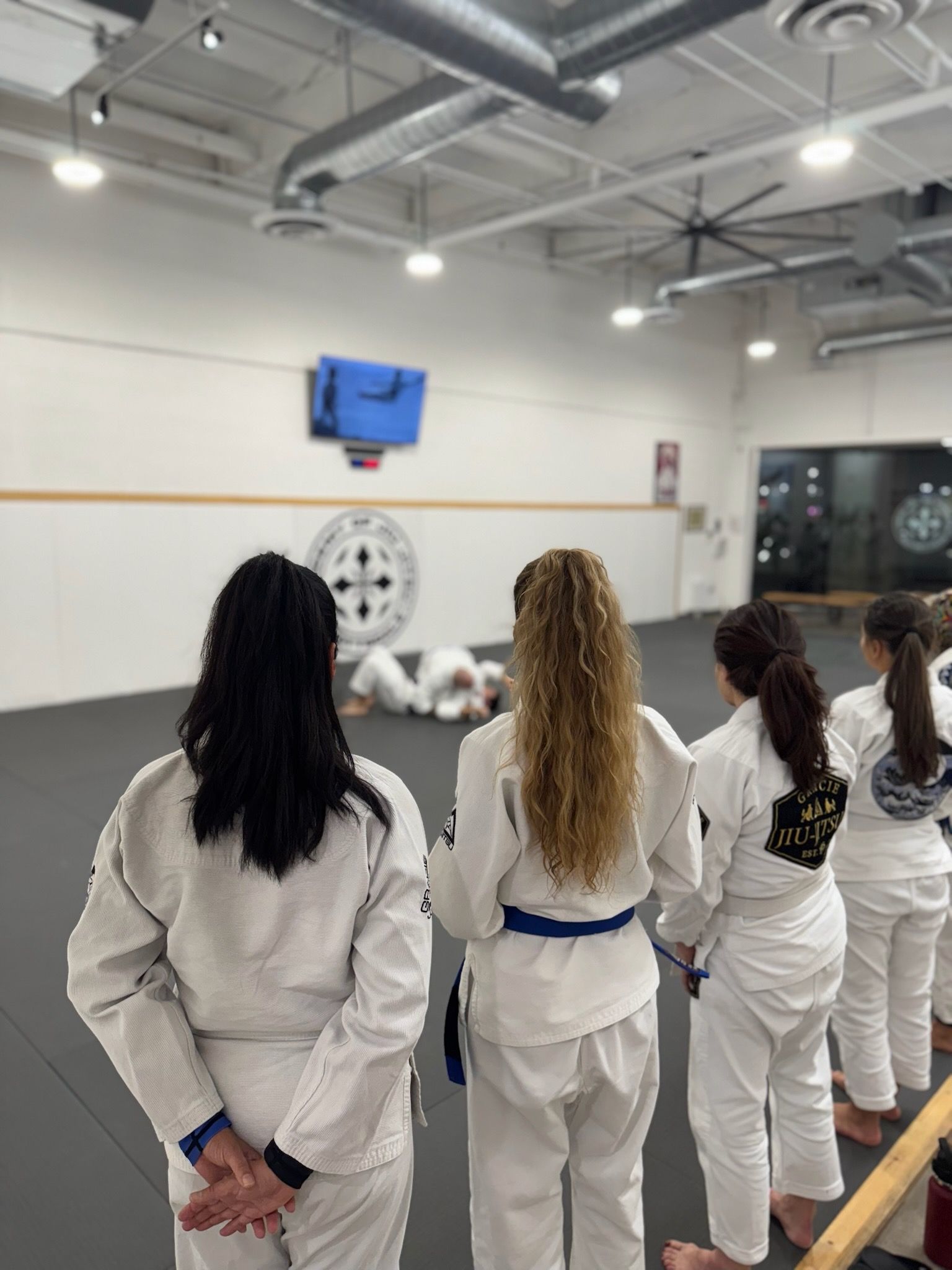 Women practicing controlled Jiu-Jitsu drills at Academy of Jiu-Jitsu Scottsdale in Scottsdale, AZ.
