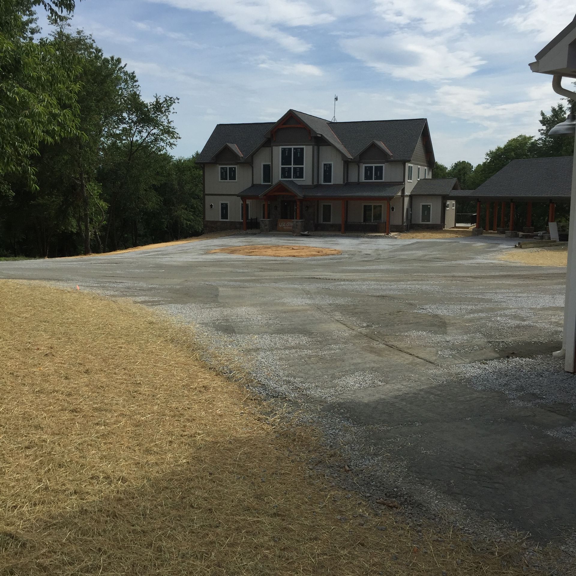 A large house with a lot of gravel in front of it.