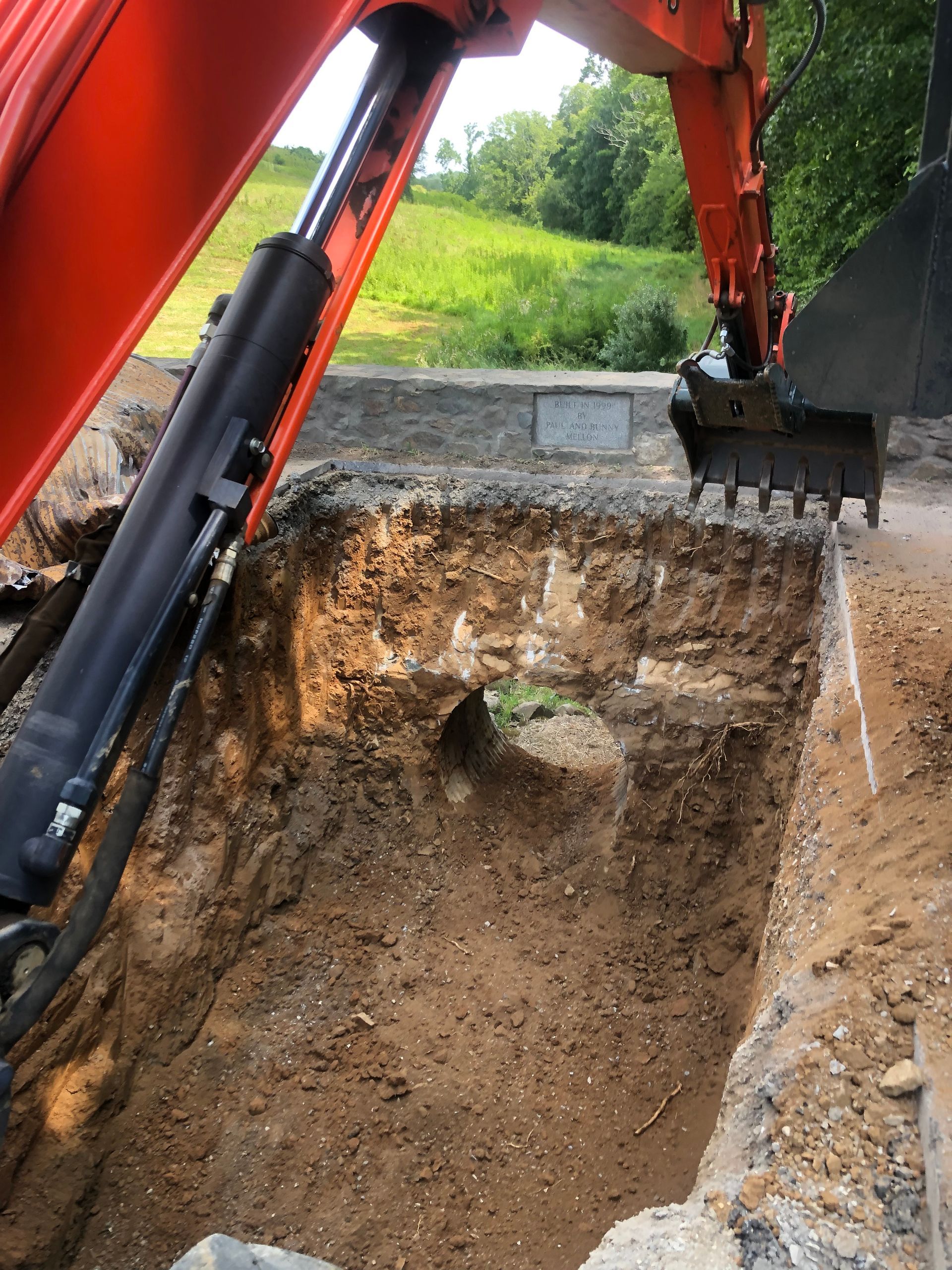 Big powerful excavator digging drainage channel in swamp in countryside.