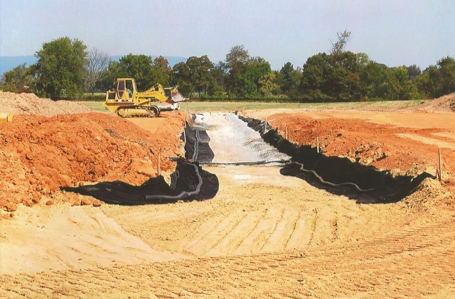 A construction site with a yellow bulldozer in the background