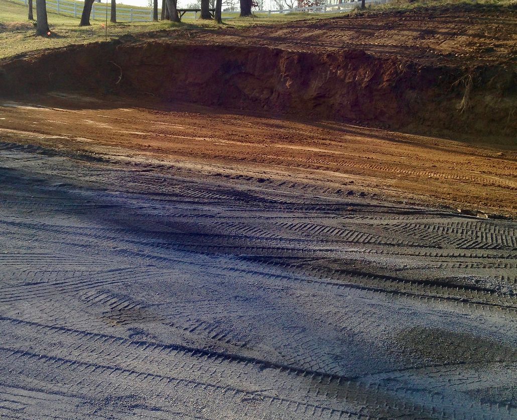 A dirt road with a lot of tire tracks on it