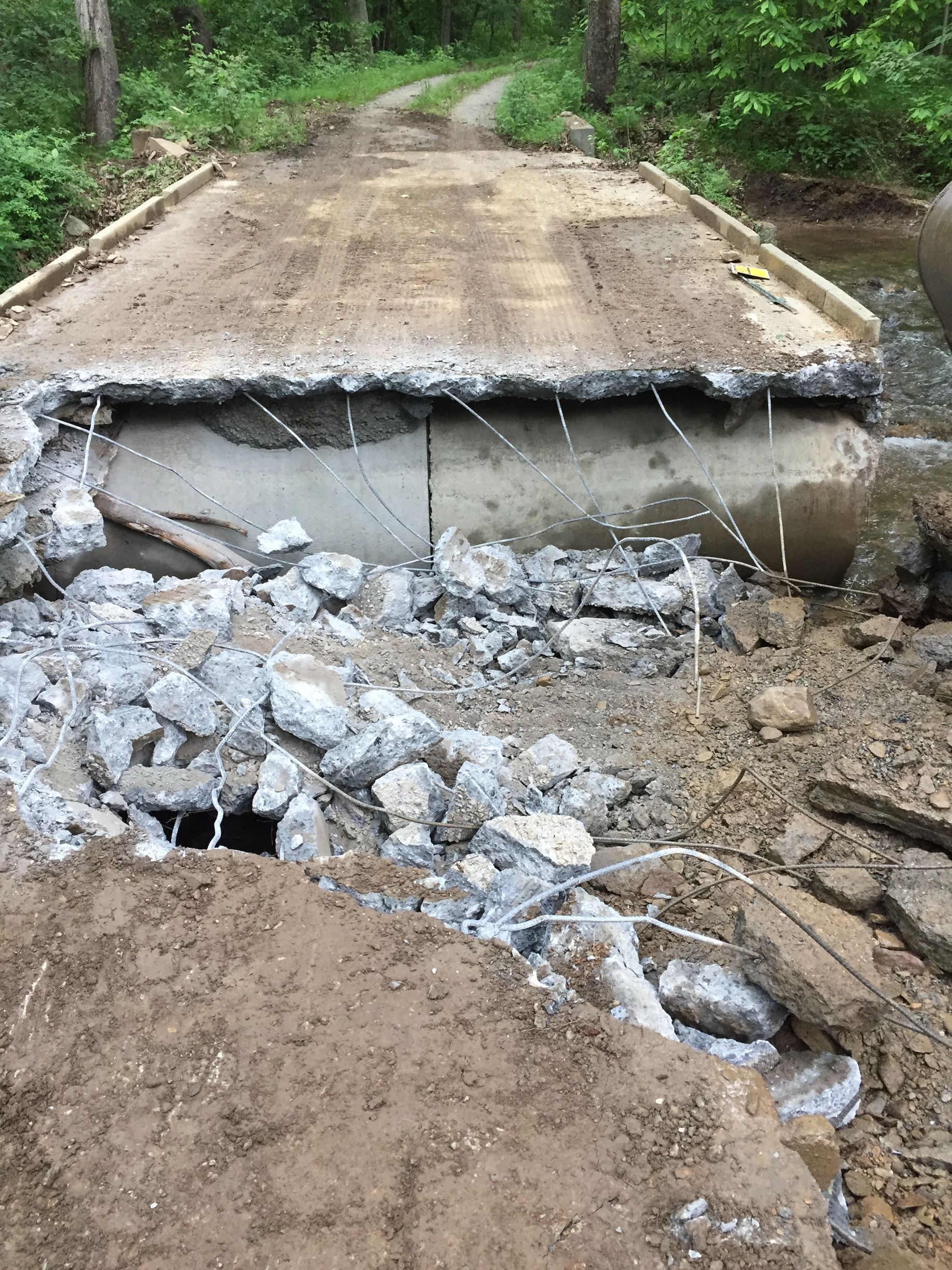 A concrete bridge is being demolished to make way for a new bridge.