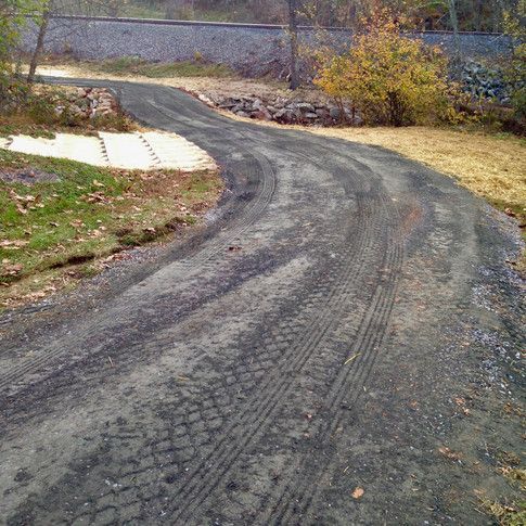 A dirt road with a lot of tire tracks on it.