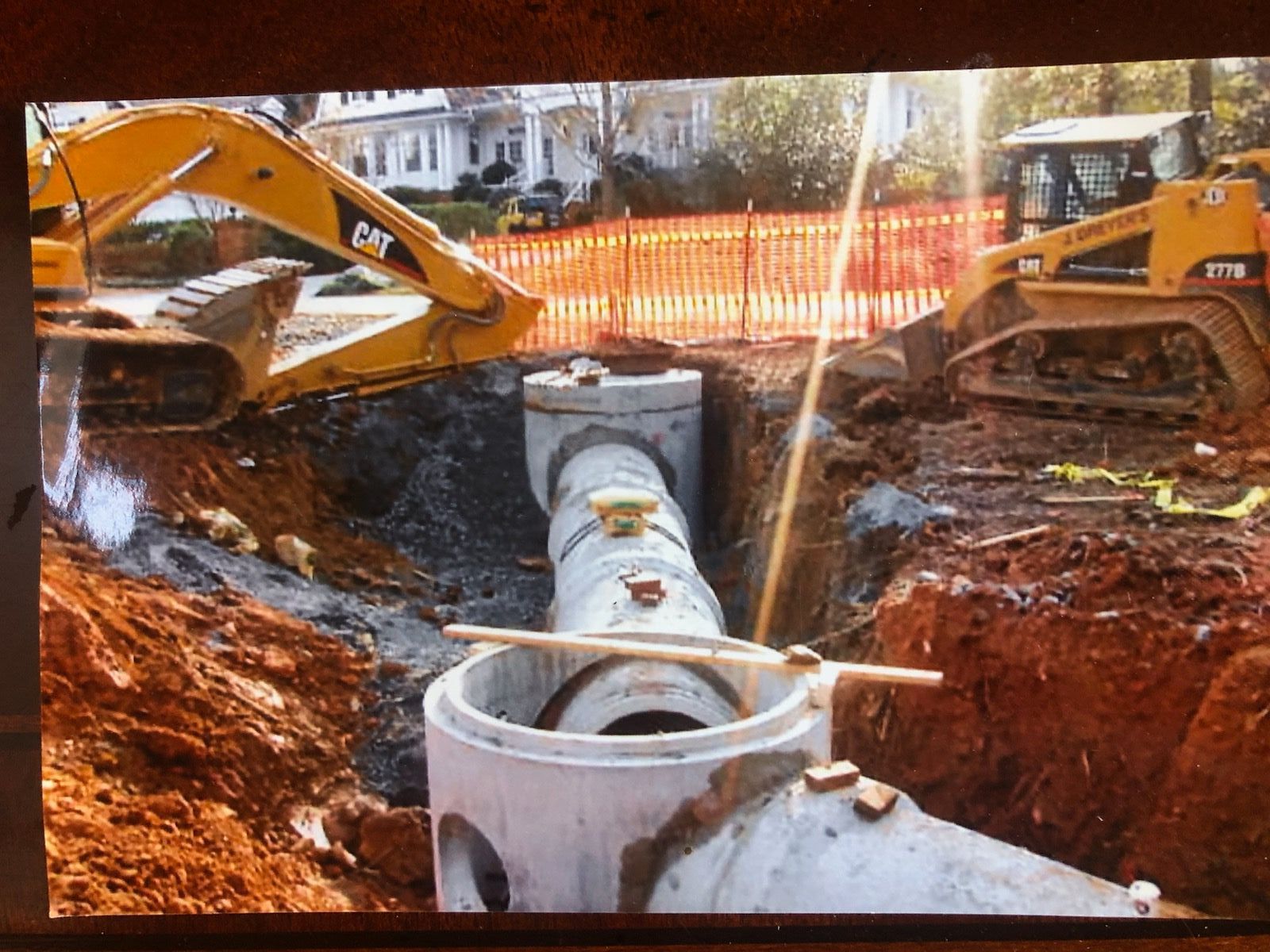 A picture of a construction site with a yellow cat excavator