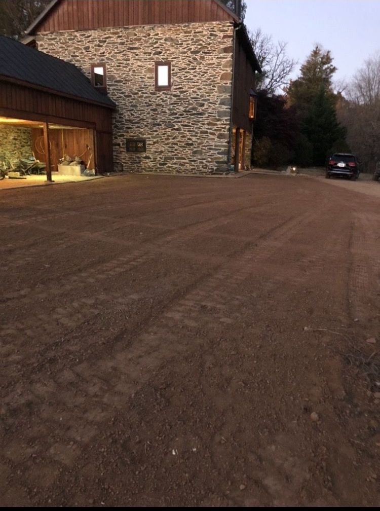 A car is parked in front of a large stone building
