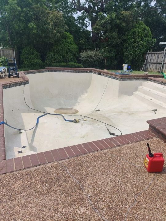 A picture of a swimming pool after being remodeled.