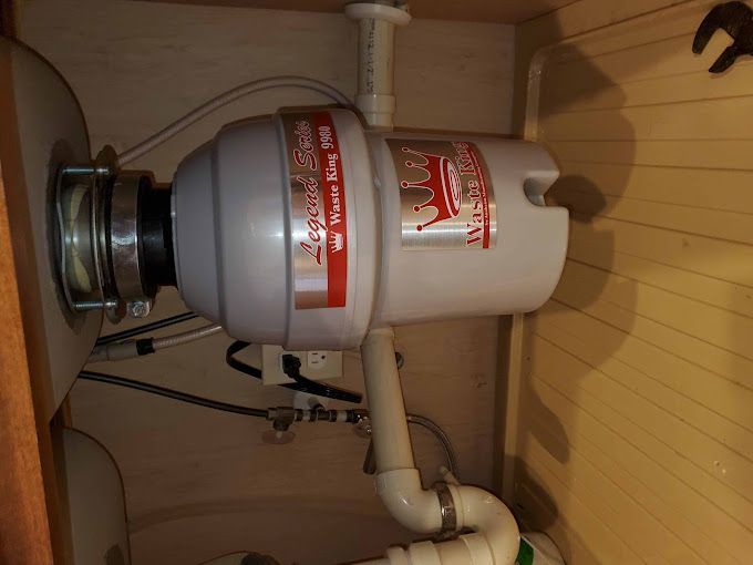 A kitchen sink with a garbage disposal underneath it