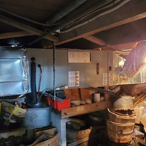 A room with a lot of boxes and buckets in it.