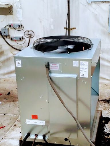 A large metal box with a fan on top of it