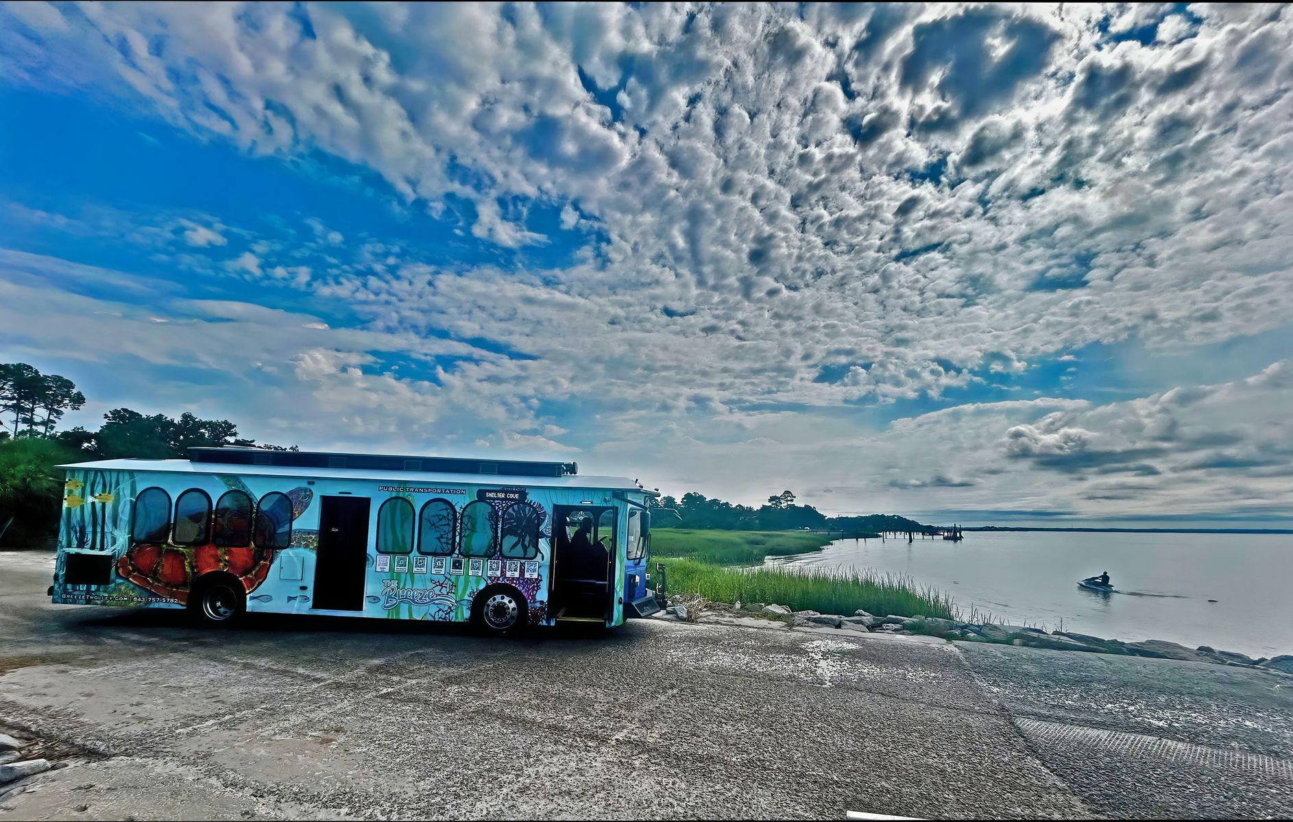 Palmetto Breeze LRTA Bus by Water with Clouds