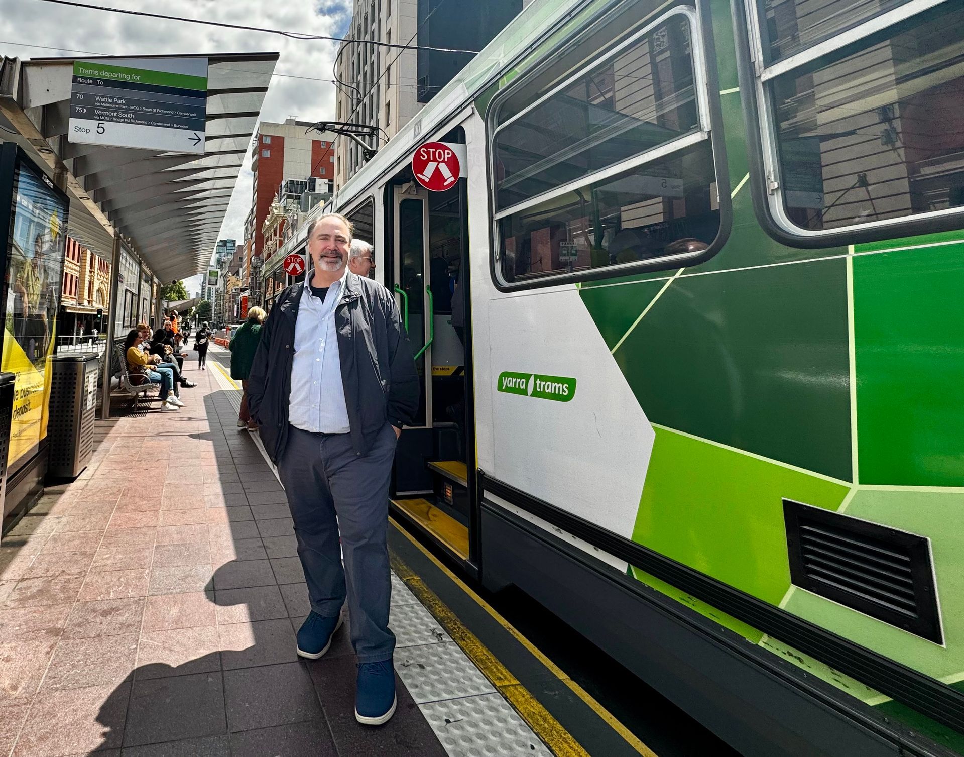 Photo of Paul Comfort next to a bus