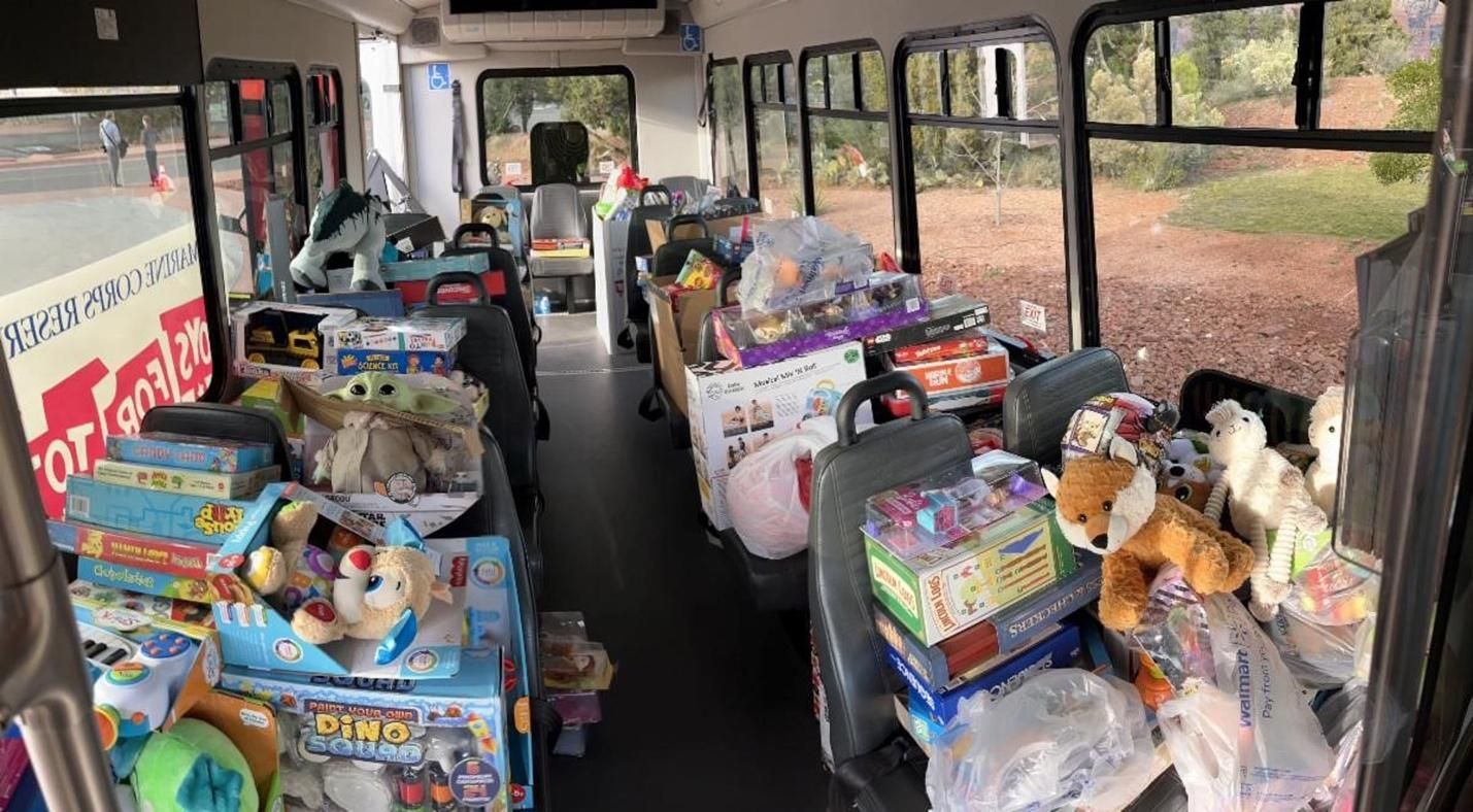 The inside of a bus filled with lots of toys.