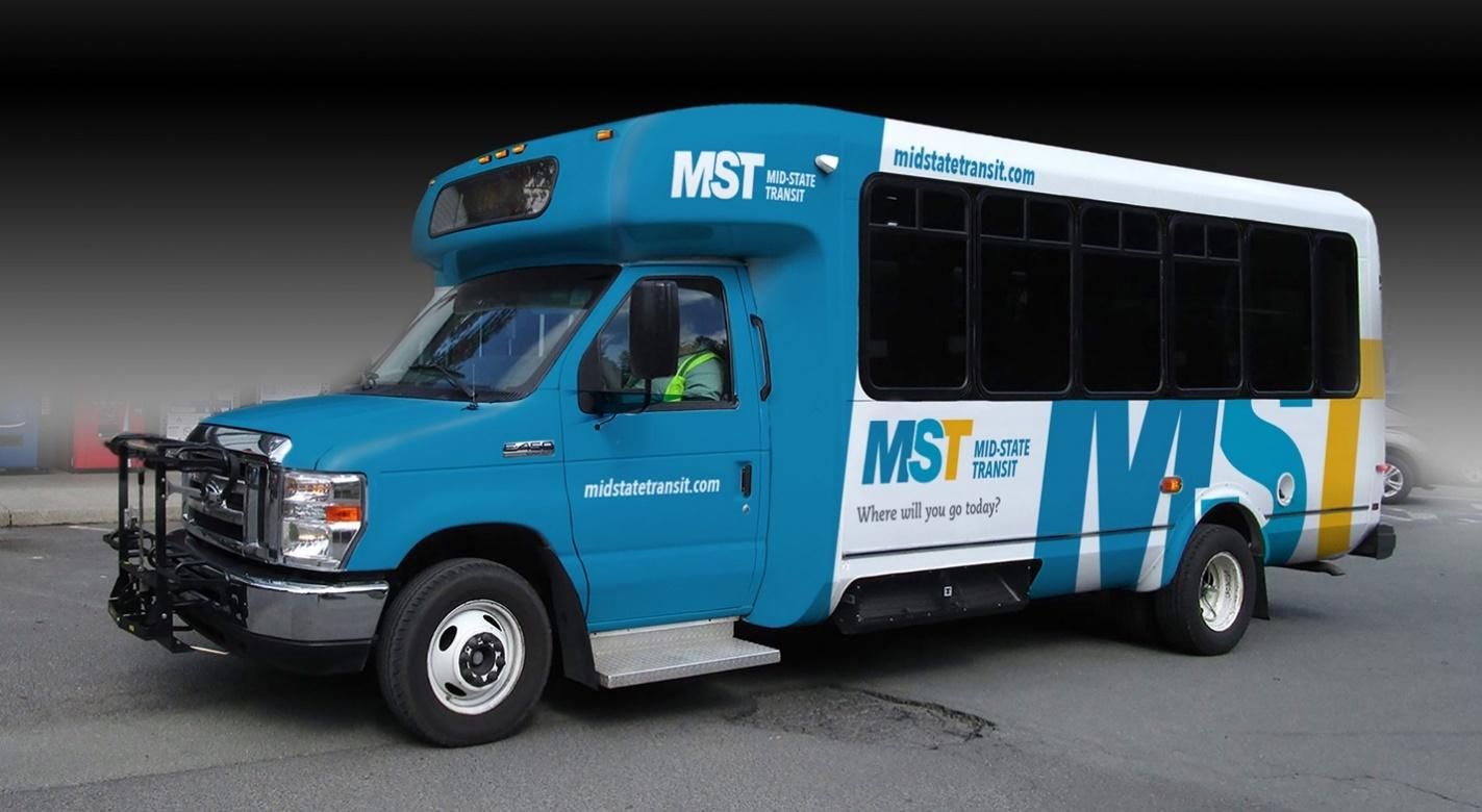 A blue and white bus with the word mst on the side.