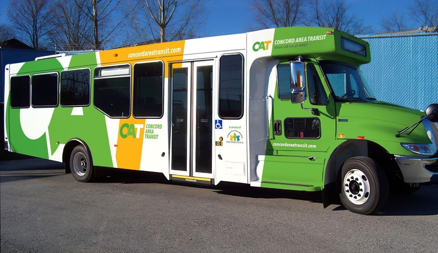 A green and white bus with the word one on the side.