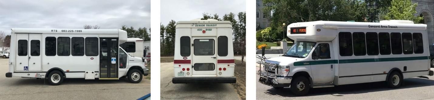 Three white buses are parked next to each other in a parking lot.