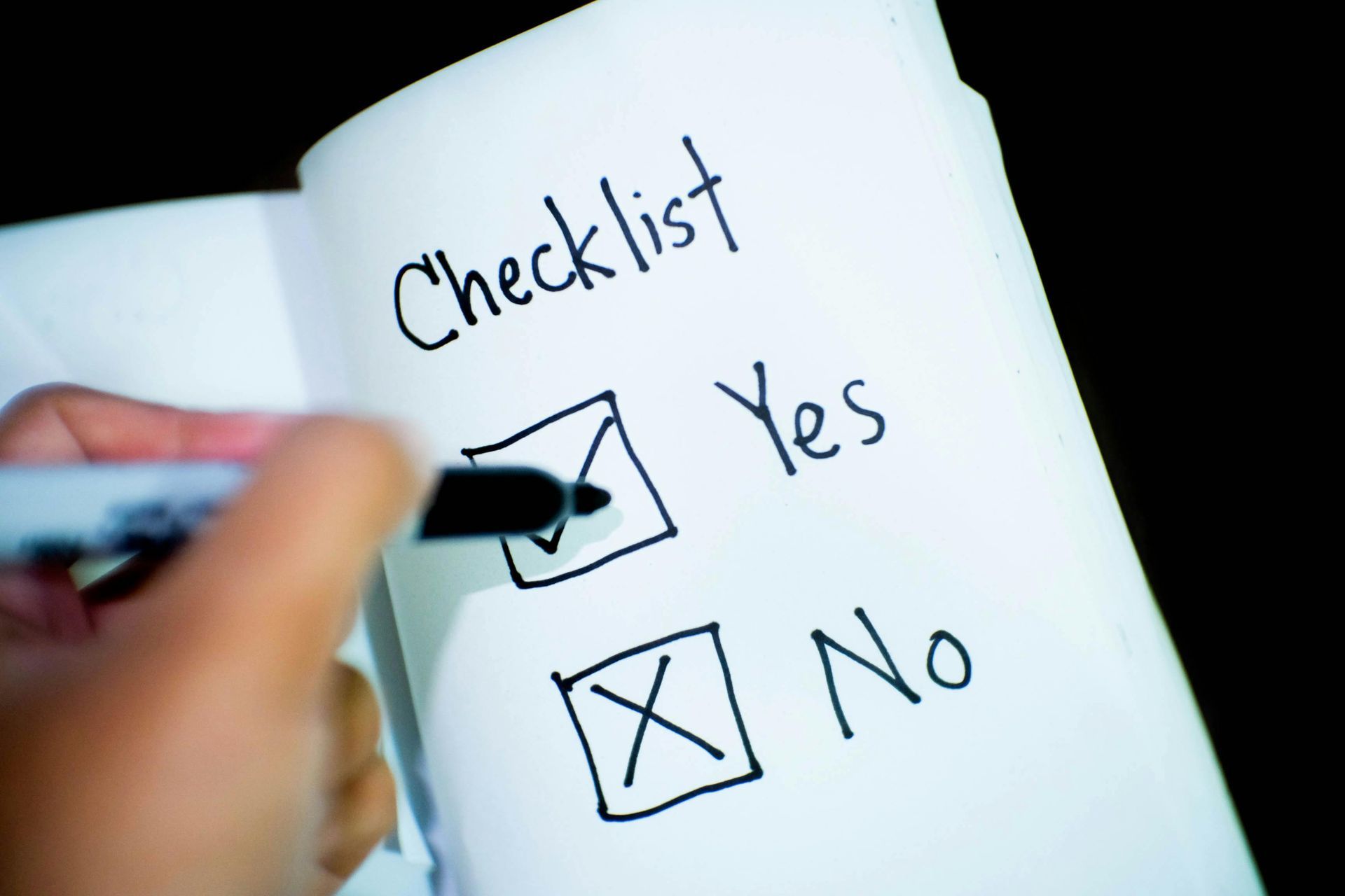 Pen writing yes in a checklist
