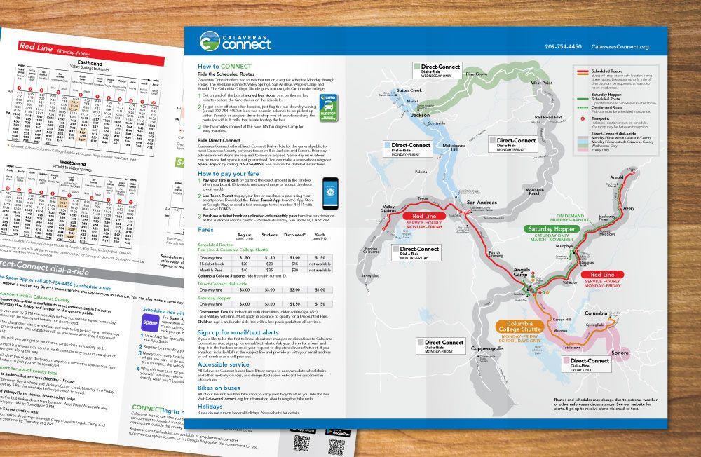 A map is sitting with bus routes and times on top of a wooden table next to a calendar.