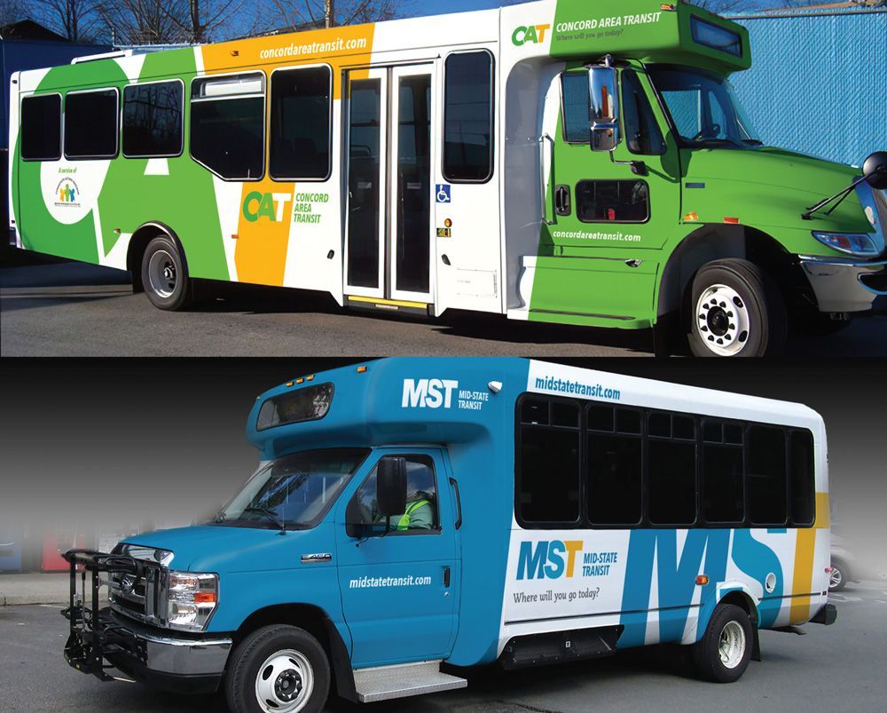 A green bus and a blue bus with mst written on the side