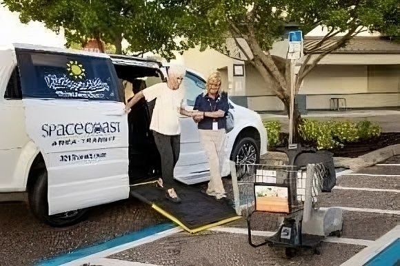 Spacecoast Volunteer helping a rider on a ramp
