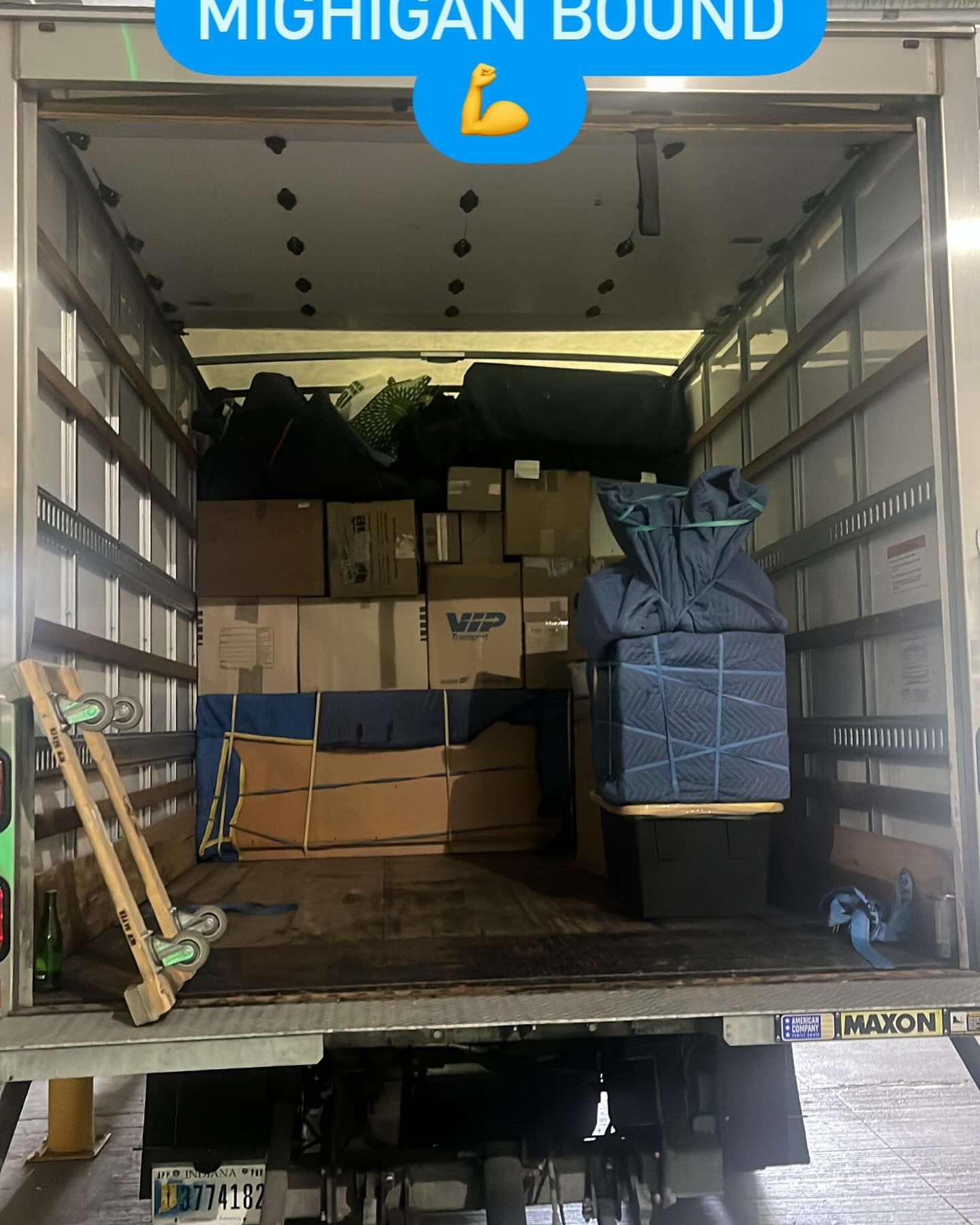 Four people assemble a light-wood bookshelf in a bright, modern living room.