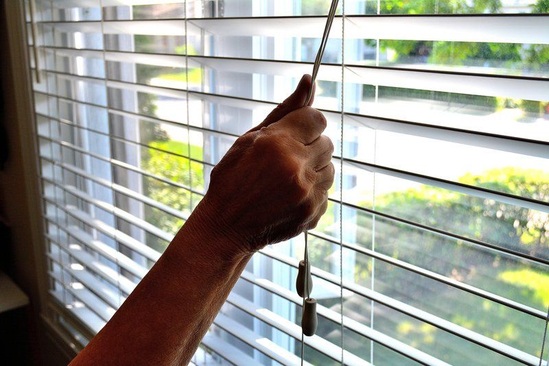 Arm Opening a Bedroom Window Blinds — Denham Springs, LA — Blinds By Tones & Textures